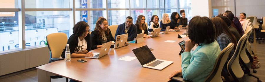 Large team meeting around a conference table