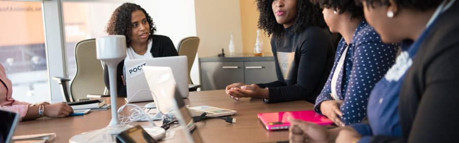 Hiring manager discussing candidates with her team around a table