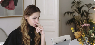 Job seeker thoughtfully reviewing job listings on her laptop