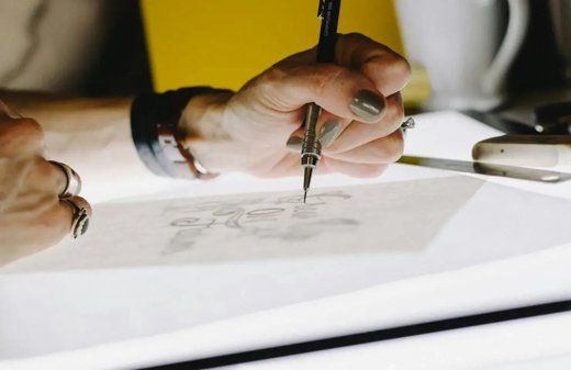 Designer sketching a hiring campaign concept